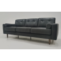 Light colored leather three person sofa