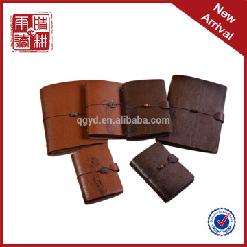 brown color notebook with metal nameplate elastic bind