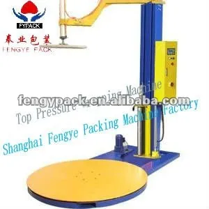 stretch wrapping machine with top holding device