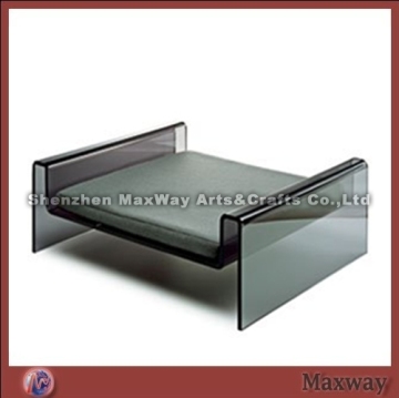 M-shaped dark lucite/acrylic pet/dog bed with gray cushion