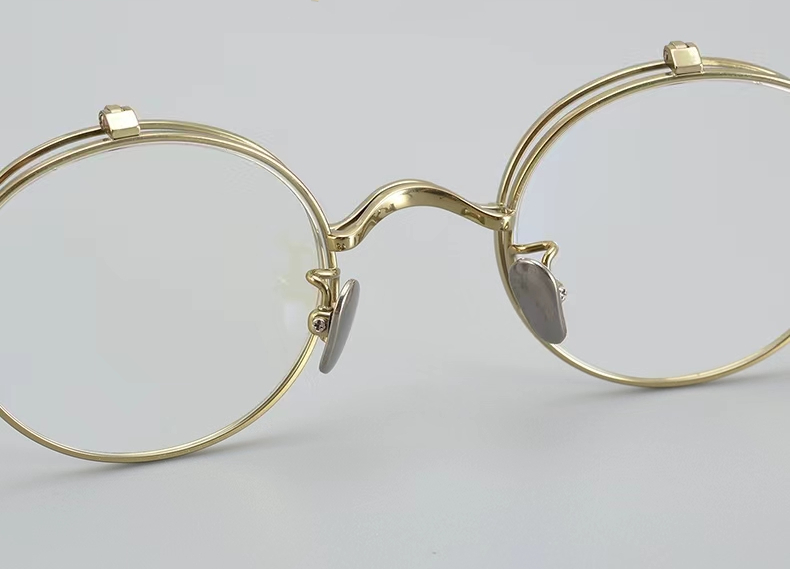 gold round titanium designer glasses