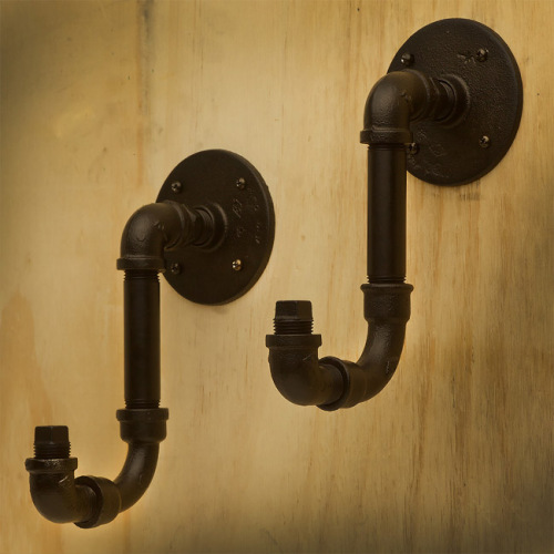 Black cast iron pipe fitting and floor flange used as hook