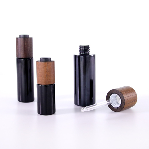 Black glass bottle with wooden lid for serum