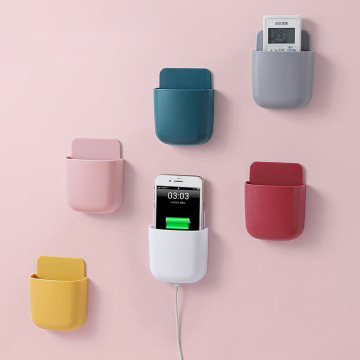 Modern design muur gemonteerde tv-afstandsbediening en oplaadrek voor mobiele telefoons