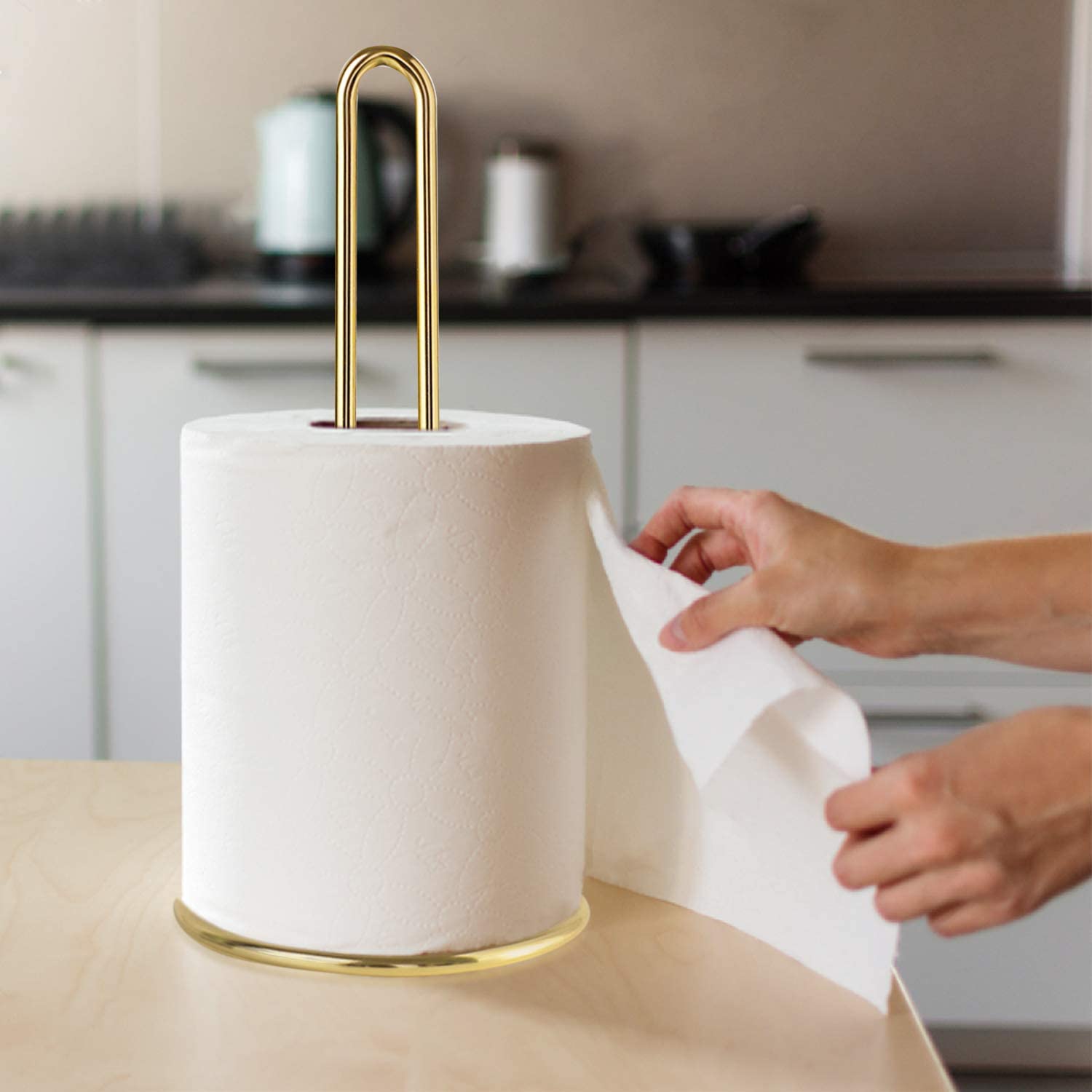 Metal paper towel holder on kitchen tabletop