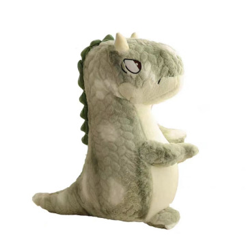 Маленькая зеленая динозавр стояла плюшевая игрушка