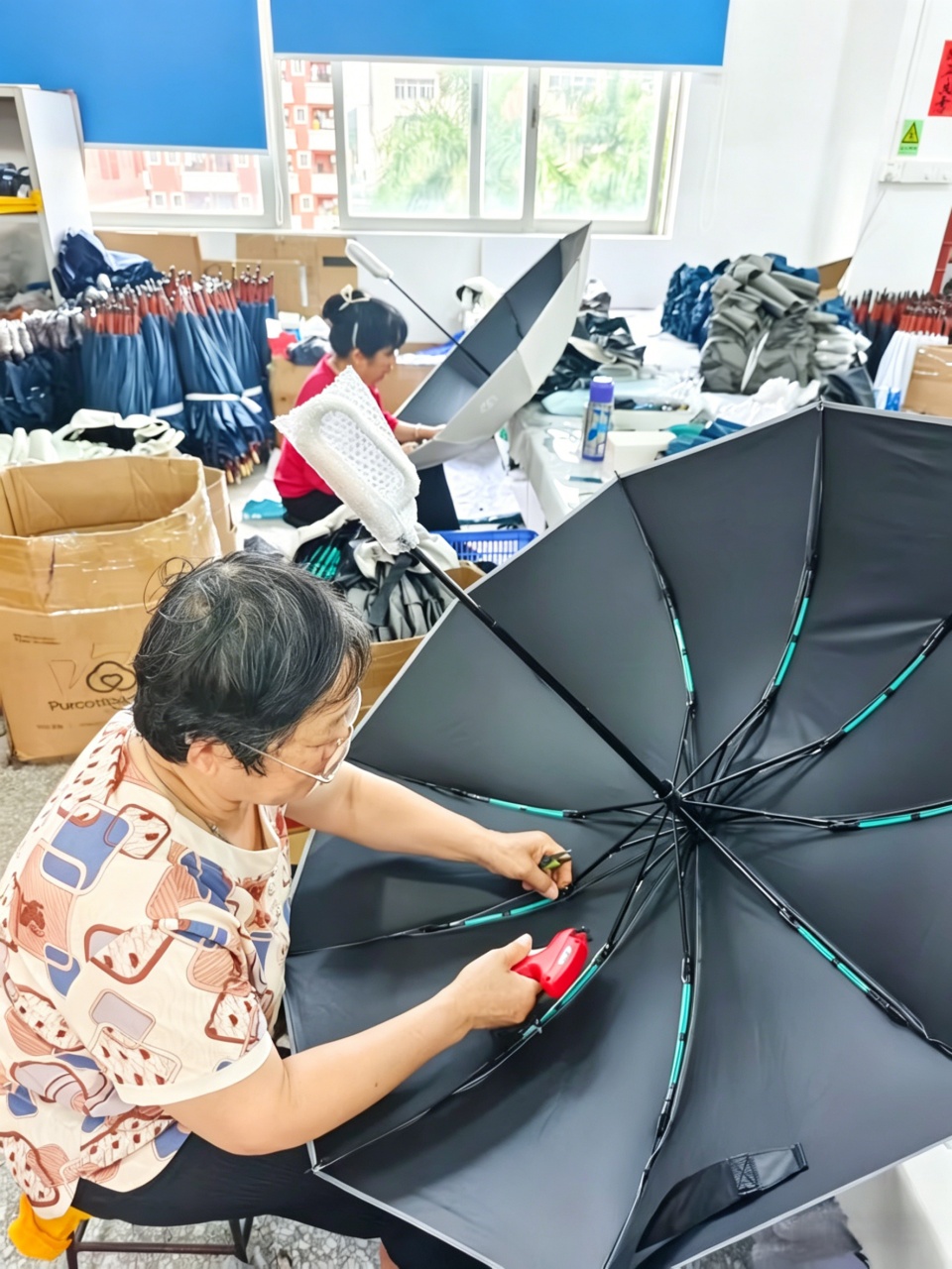 Worker-sewing-umbrella-canopy-final-assembly