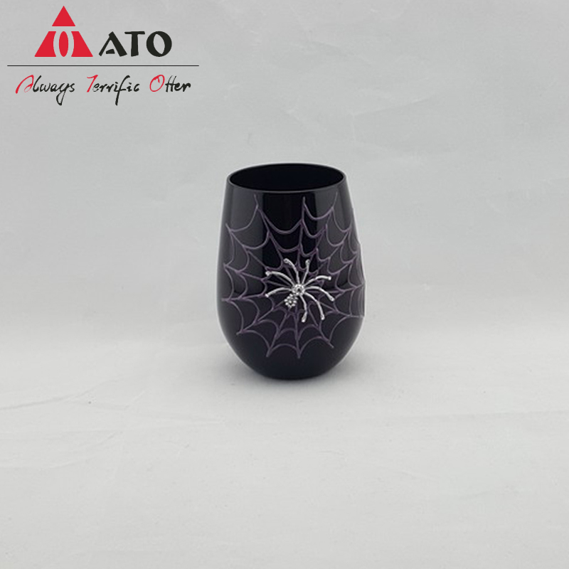 Black tumbler glass with spider pattern wine goblet