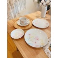 Porcelain rendered coffee cups, plates, bread plates