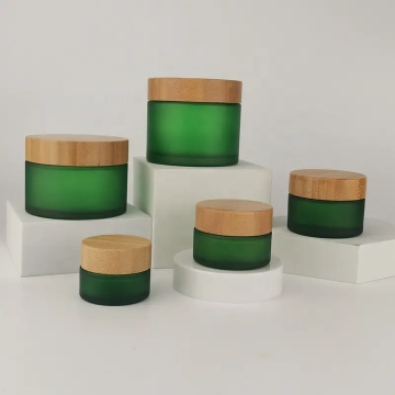 Frosted green cosmetic glass jar with bamboo lid