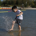 Schwimmwasserabweisende Kinder, die kurz schwimmen