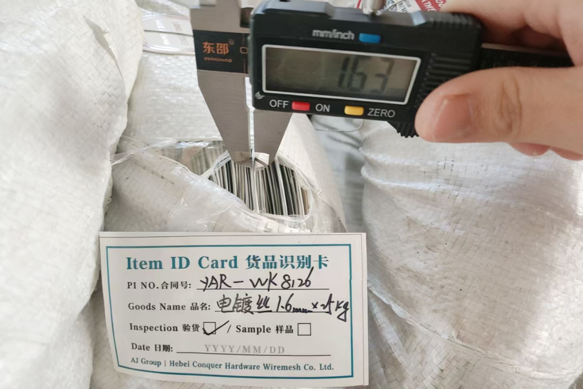 Quality control inspection of galvanized binding wire diameter with digital caliper
