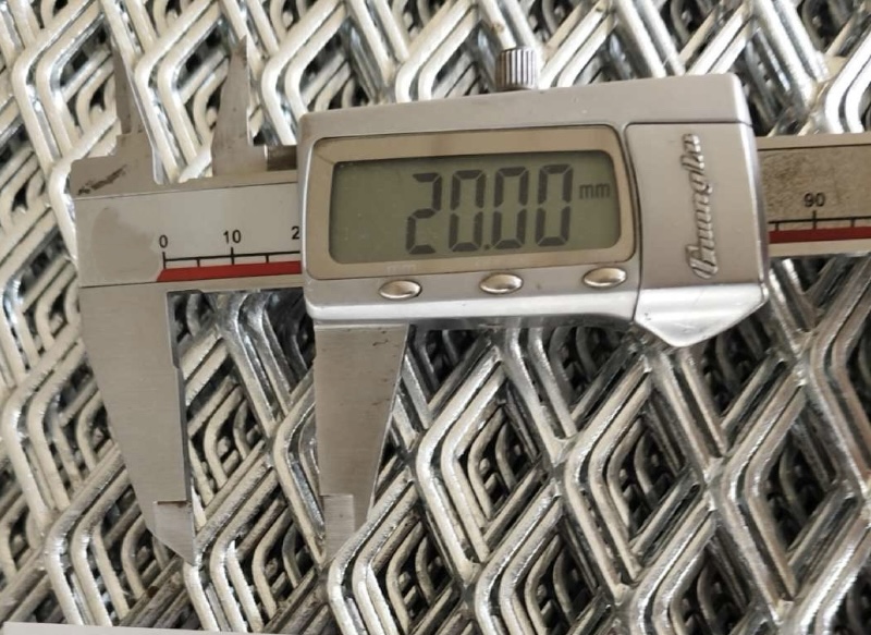 Technical inspection of expanded metal sheet dimensions using digital caliper for industrial safety compliance
