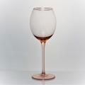 pink colored wine glass set with gold rim