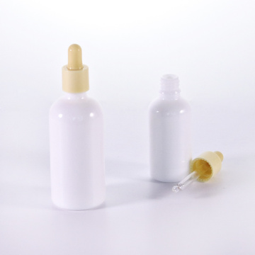Botella de aceite esencial de vidrio blanco con cuentagotas amarillas