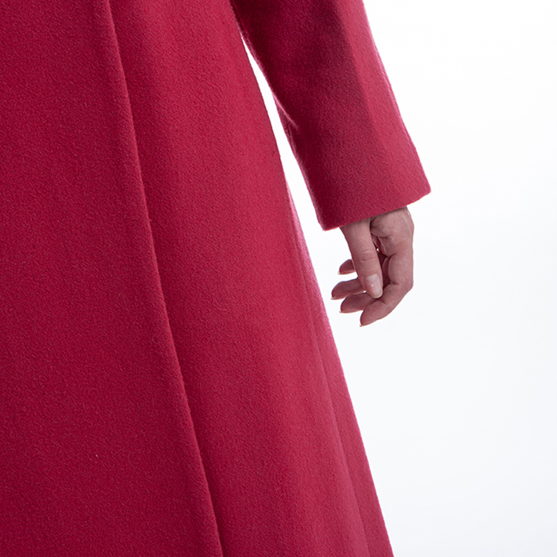 The sleeves of a red cashmere overcoat