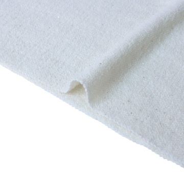 クリームホワイトのウールニット生地とゴールドのスパンコール