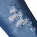 Jeans a campana strappato magro per le donne