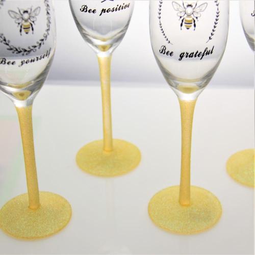 China champagne flute glass bee design glitter glass set Supplier