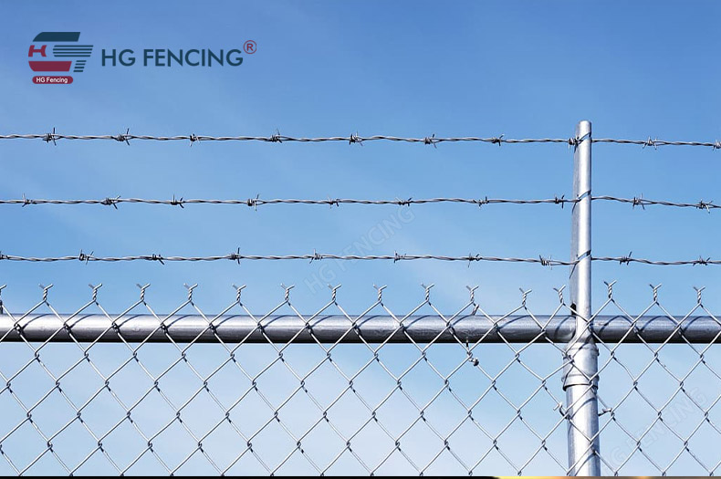 Barbed wire mounted on top of chain link fence