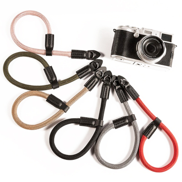 Durable Adjustable Comfortable DSLR Outdoor Climbing Camera Wrist Strap" could be shortened to "Adjustable DSLR Camera Wrist Strap for Outdoor Climbing" as a suitable title for a search engine. However, if we need exactly one phrase from the given text, "