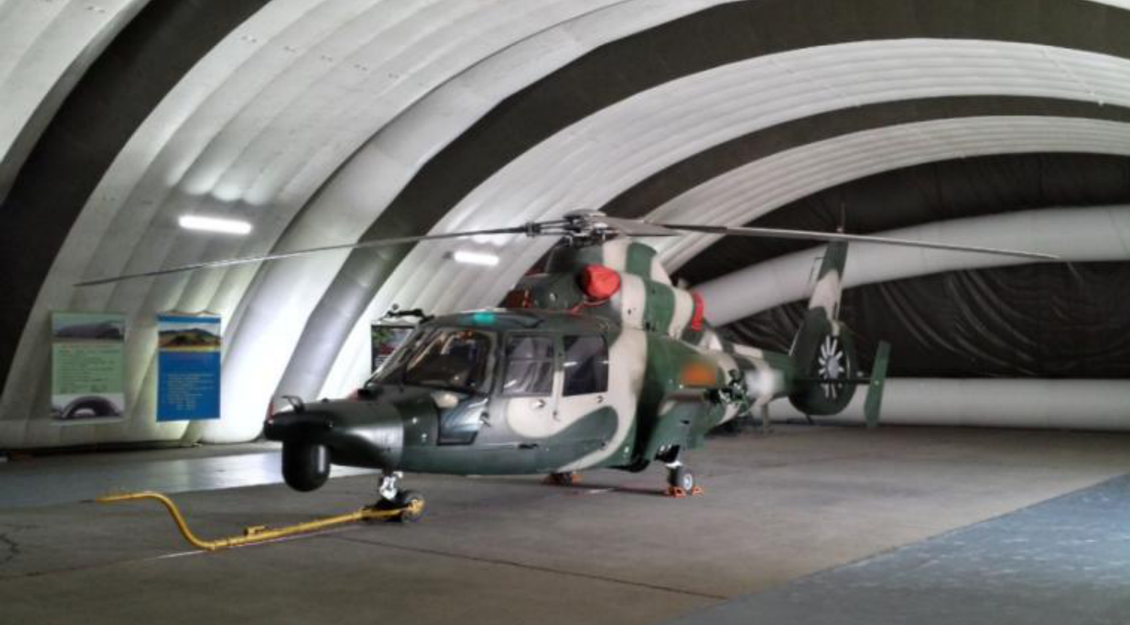 EXTRA aircraft parked in front of an inflatable hangar