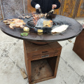 Corten steel fire pit with wooden grill bbq