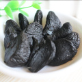 Peeling organic black garlic