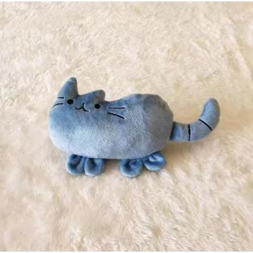 Small pillow with blue kitten stuffed animal