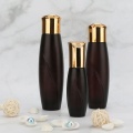 Brown Cosmetic glass bottle with golden caps