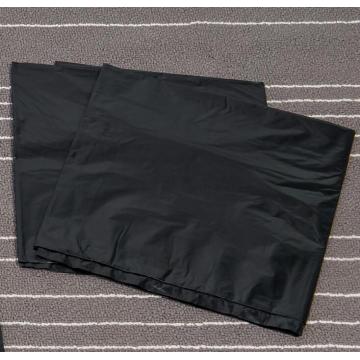 Large Black Garbage Bag on Sheet