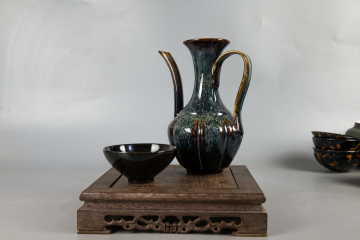 Two sets of hand holding teapot and tea set