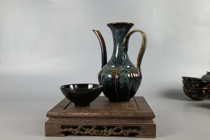 Two sets of hand holding teapot and tea set