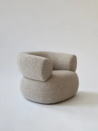 Moving Mountains Puffer chair by boucle fabric