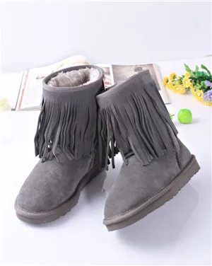 Warm female boots with tassels