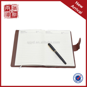notebook with pen attached