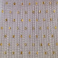 Tessuto in tulle increspato con stampa laminata a pois dorati