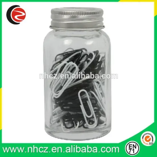 black and white paper clips in glass jar