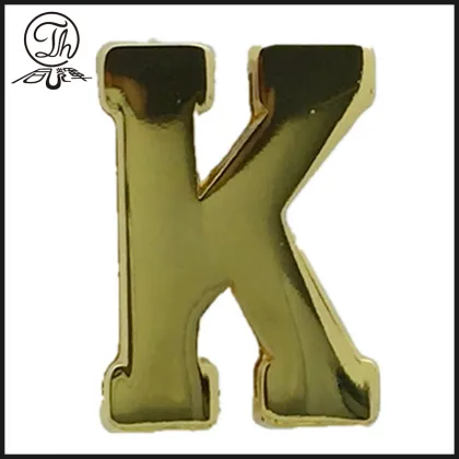 Gold K letter plate on the leather bag