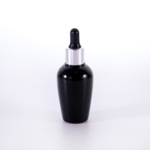 Black glass bottle with silver dropper cap