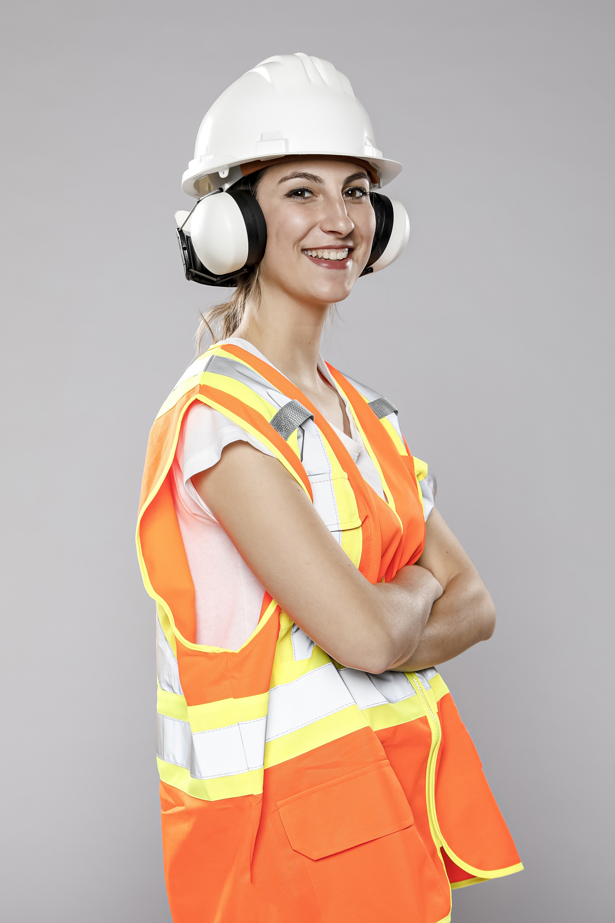 side-view-smiley-female-engineer-with-helmet