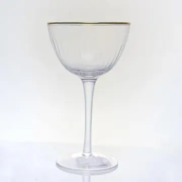 ribbed champagne flute glass with gold rim