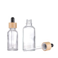 Botellas de gotero de vidrio transparente contenedor cosmético de tapa de bambú