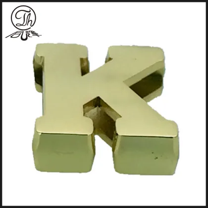 Gold K letter plate on the leather bag