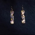 Des boucles d'oreilles conçues "Nightfall" appliquent