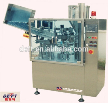 Plastic tube filling and sealing machine