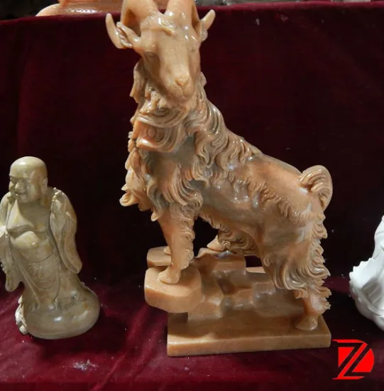 small stone goat sculpture