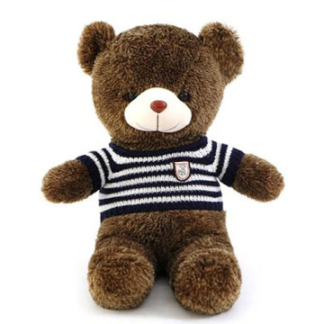 Small black bear stuffed animal with striped sweater