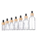 Botellas de gotero de vidrio transparente contenedor cosmético de tapa de bambú