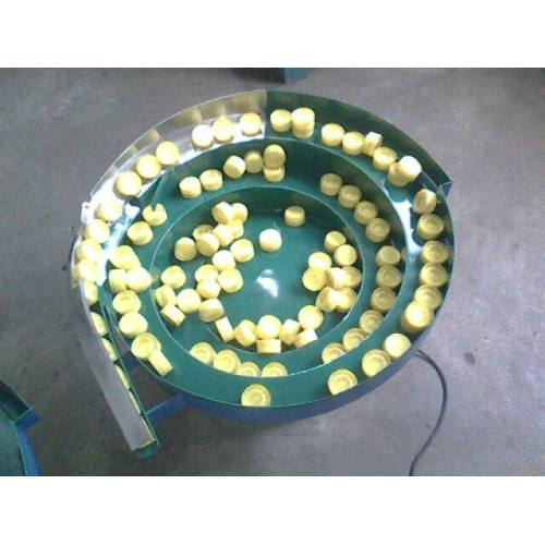 Tube cap vibrating plate feeder